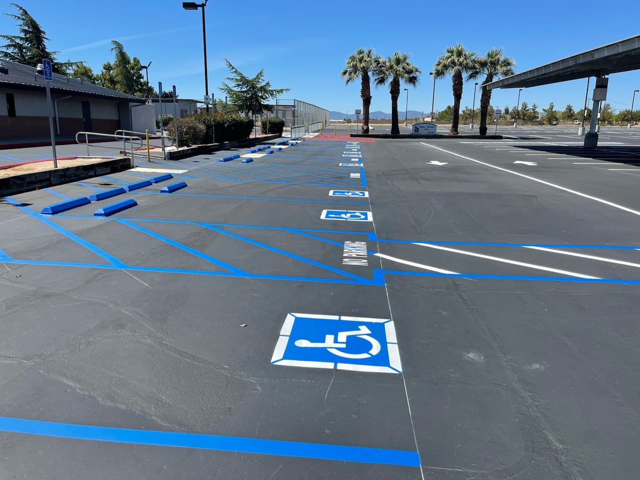 Change the grade level for ADA stalls to be in compliance. Updated handicap signs to new ADA standard. Re-striped the parking stalls and all stalls in parking lot.