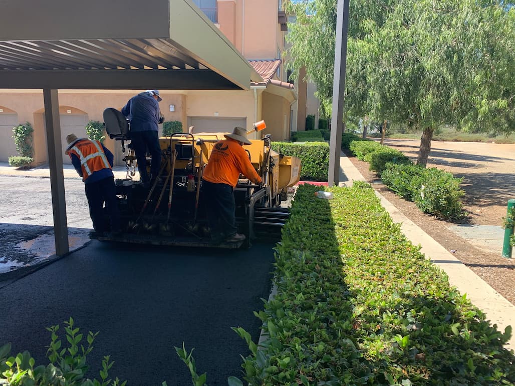 Grind down existing asphalt and overlay with new asphalt at an apartment complex.