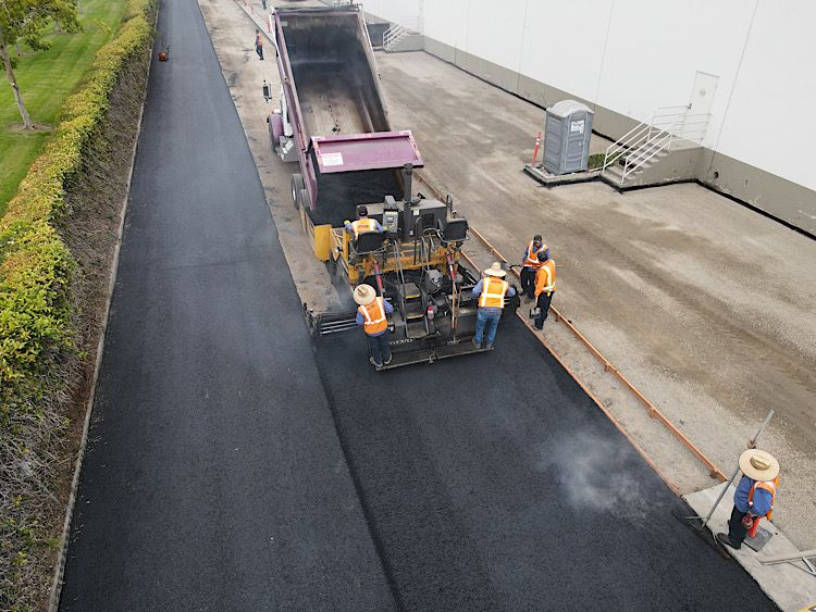 Asphalt Repair by removing and replacing it with new asphalt in a truck yard at a commercial building.