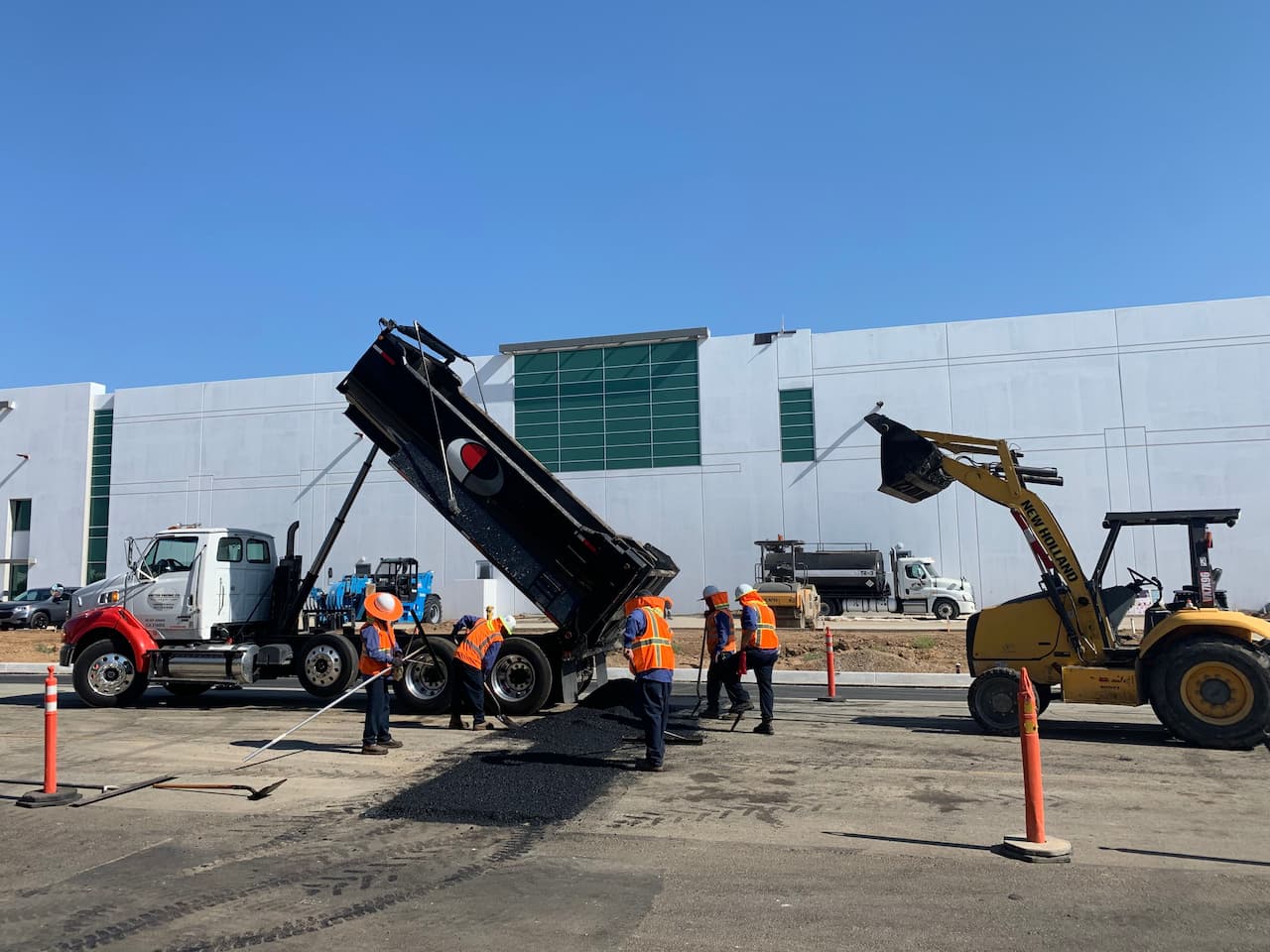 Repaving asphalt at a commercial building property.