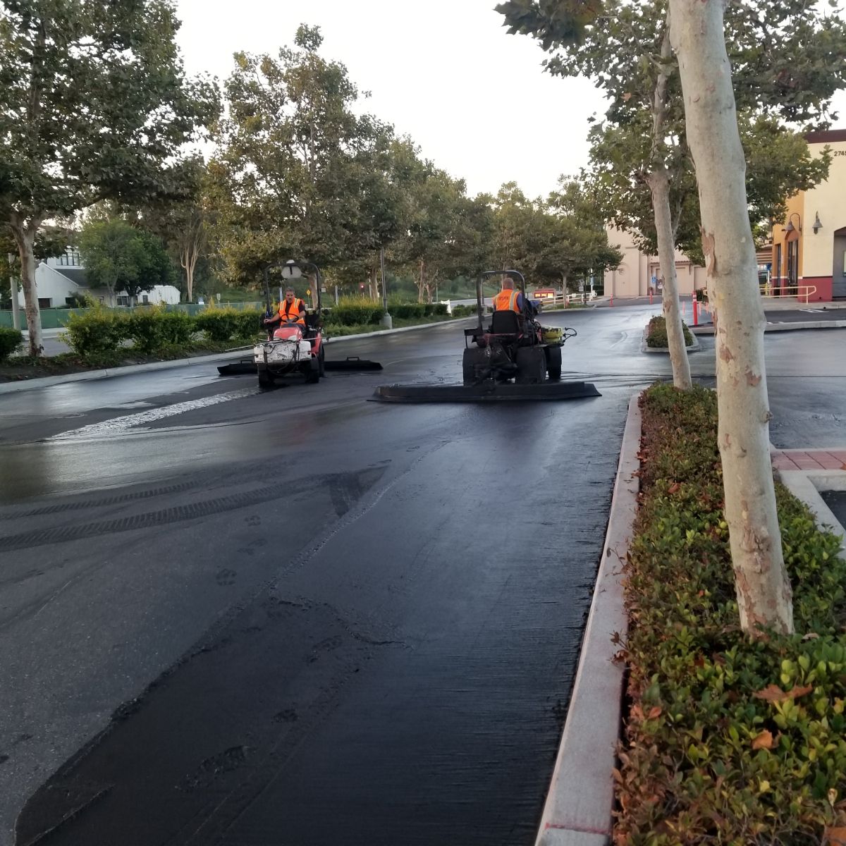 Seal coating parking lot at a commercial retail shopping center.